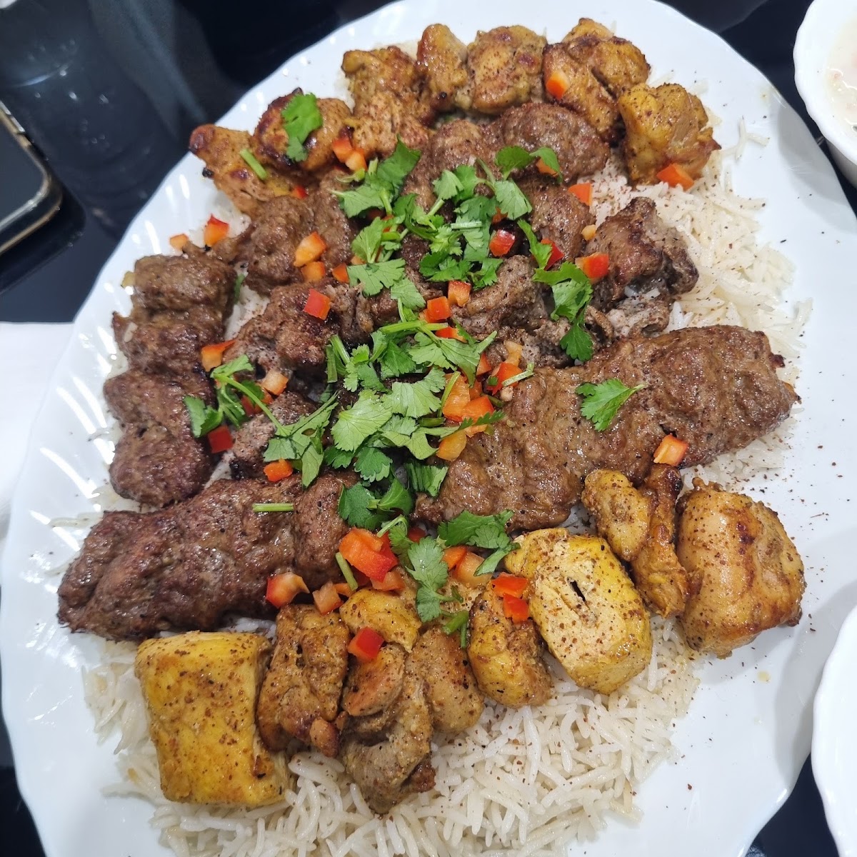 Mixed kebab platter with chicken and beef boti over rice