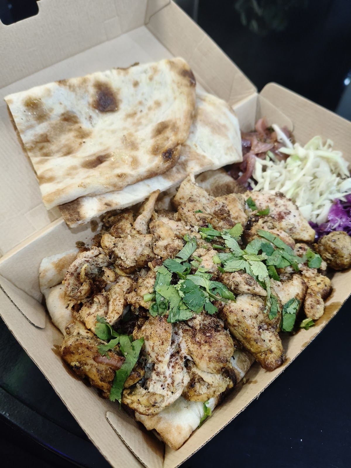 Grilled chicken over fresh naan with slaw