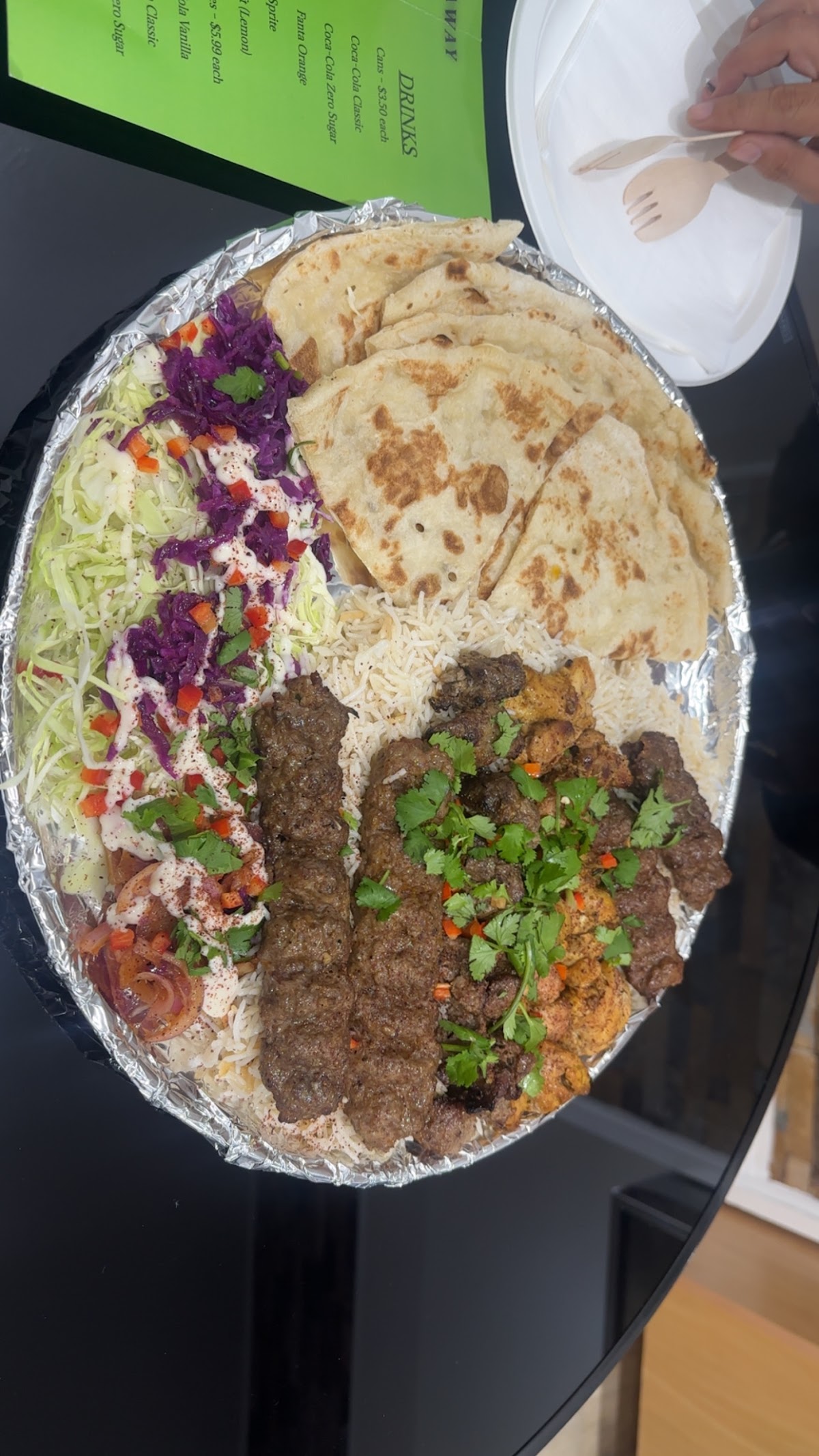 Party platter with kebabs, rice, naan and salads